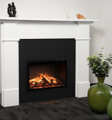 Regency Ei25 Electric Fireplace Insert in a white case with a decorative vase on top, adding warmth and style to a cosy interior space