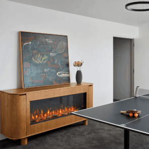 A ping pong table and an EmberArc Ashton 180 fireplace create a recreational and relaxing atmosphere in the room
