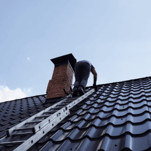 Fireplace Safety - Man climbing up to the roof to clean chimney