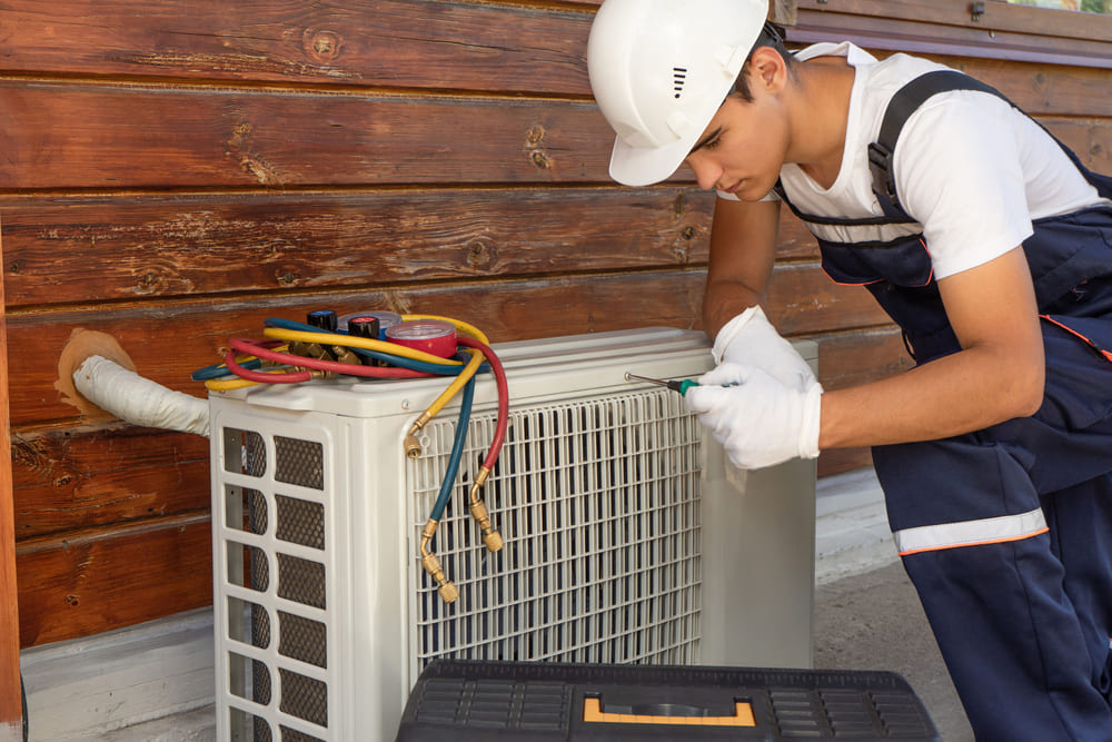 technician checking ac split system outer unit