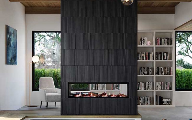 Real Flame Element 1200 DS Gas Fireplace installed in a modern living room beside a bookshelf wall, creating a warm and stylish atmosphere