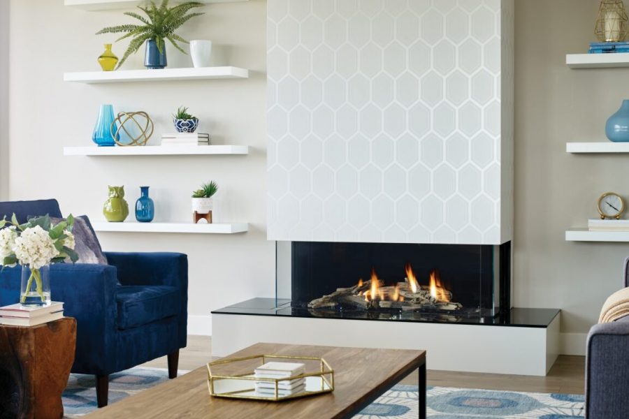 A stylish living room with blue furniture and a gas fireplace, creating a cosy and inviting space ideal for gatherings and relaxation