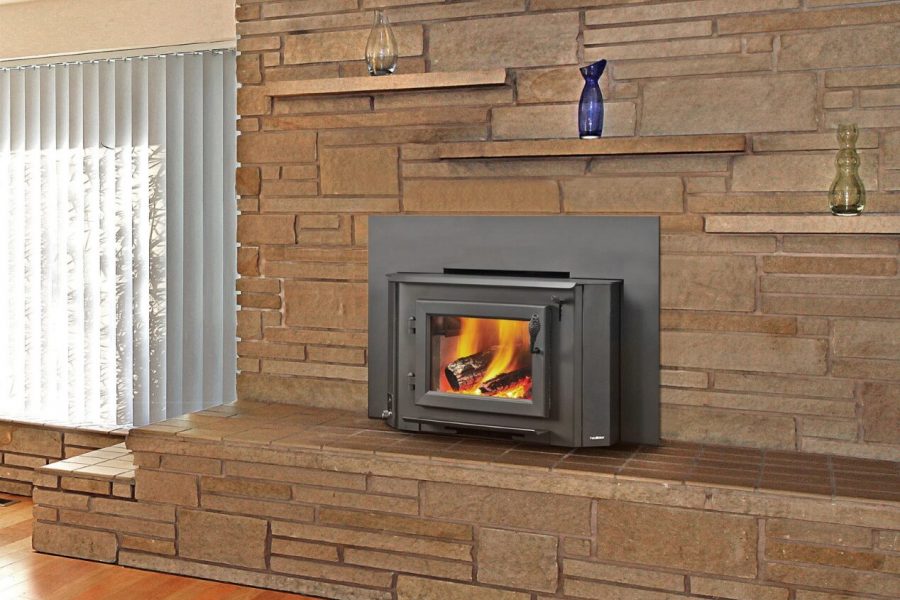 A heatilator wood-burning stove insert installed in a brick wall, creating a cosy and warm atmosphere in the living space