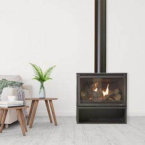 A simple living room with a Heat & Glo I30-X Freestanding wood burning stove, creating a warm atmosphere