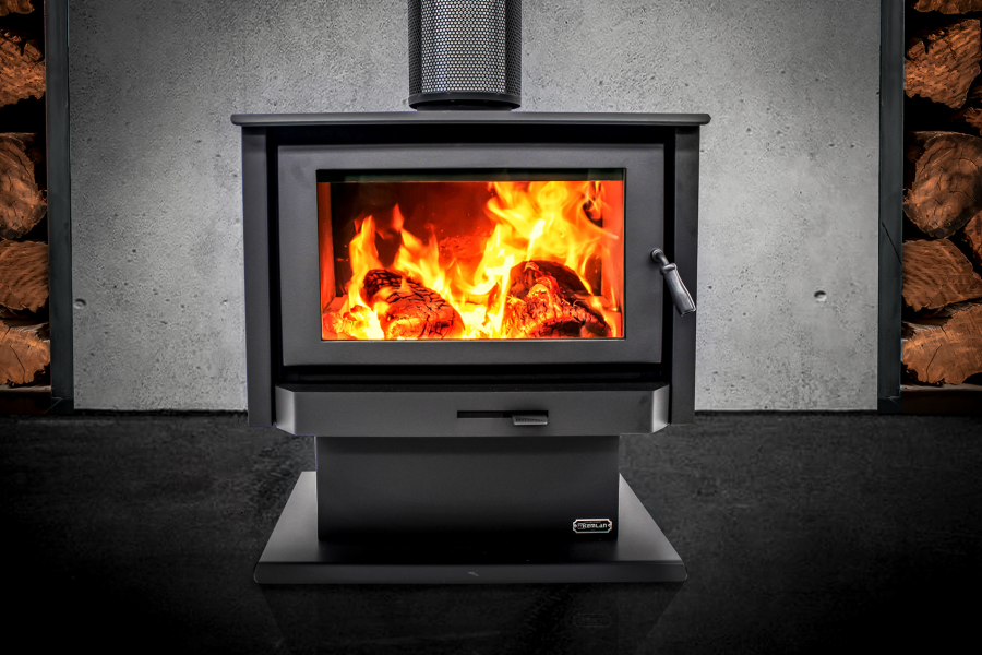 Kemlan Tempo Series Wood fireplace in a cosy room with neatly stacked logs nearby