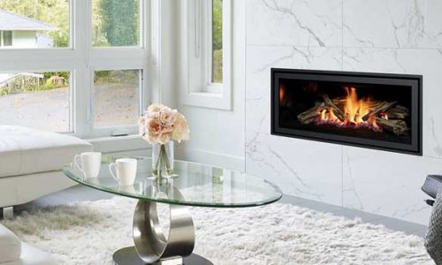 A Regency GF950L gas fireplace in a living room featuring elegant white furniture